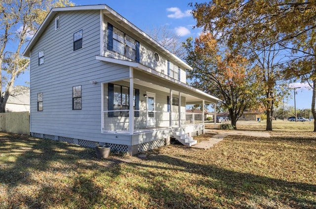 view of side of property featuring a yard and covered porch