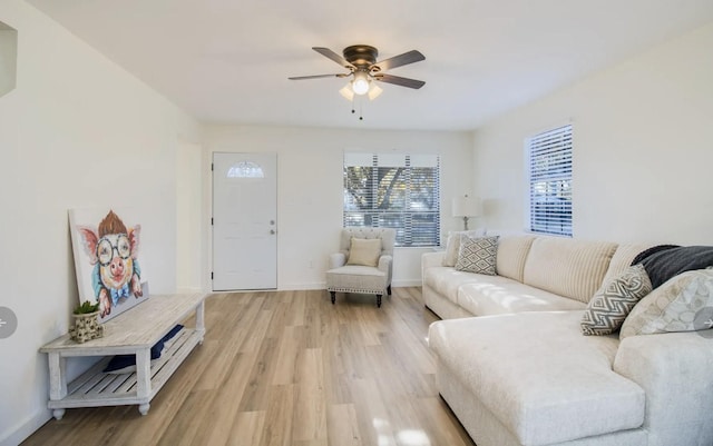 living room with light hardwood / wood-style flooring and ceiling fan