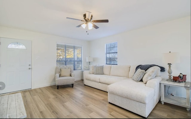 living room featuring ceiling fan and hardwood / wood-style flooring