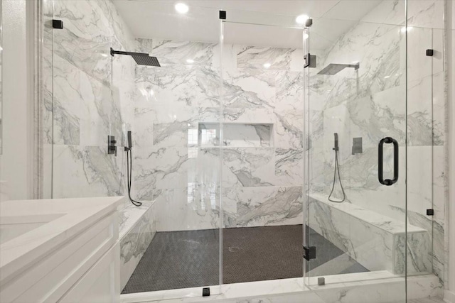 bathroom featuring a marble finish shower