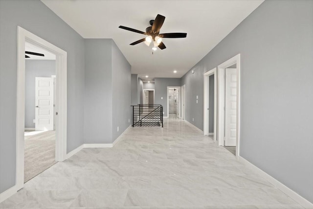 hall featuring baseboards and an upstairs landing