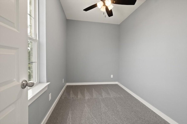 carpeted empty room with a healthy amount of sunlight, baseboards, and a ceiling fan