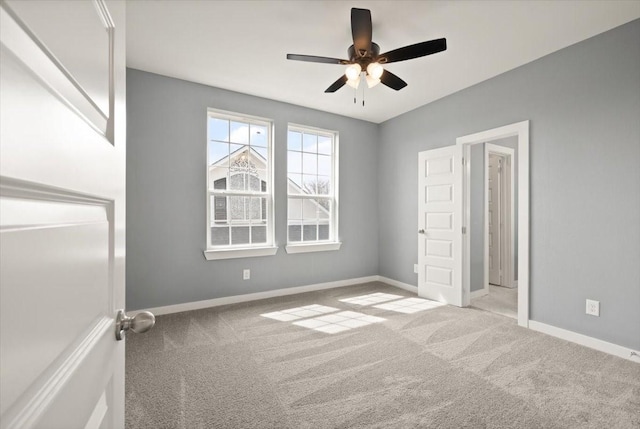 unfurnished bedroom featuring ceiling fan, carpet, and baseboards