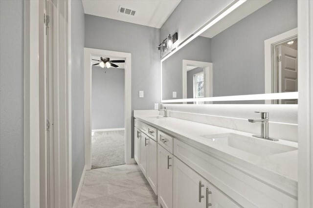 bathroom with ceiling fan, visible vents, a sink, and double vanity