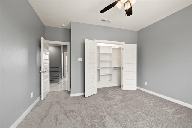 unfurnished bedroom with a closet, baseboards, and carpet flooring