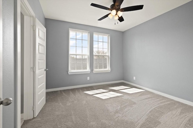 unfurnished room featuring carpet flooring, ceiling fan, and baseboards