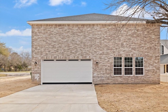 view of front of property featuring concrete driveway and brick siding