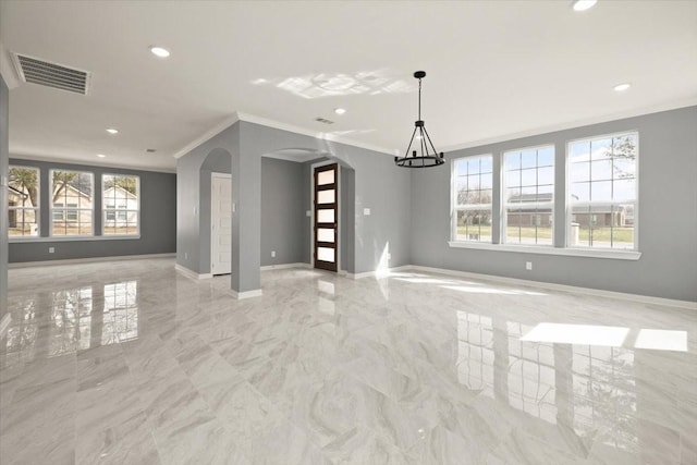 spare room with baseboards, visible vents, arched walkways, ornamental molding, and marble finish floor