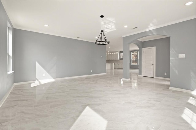 unfurnished living room featuring arched walkways, recessed lighting, baseboards, marble finish floor, and ornamental molding