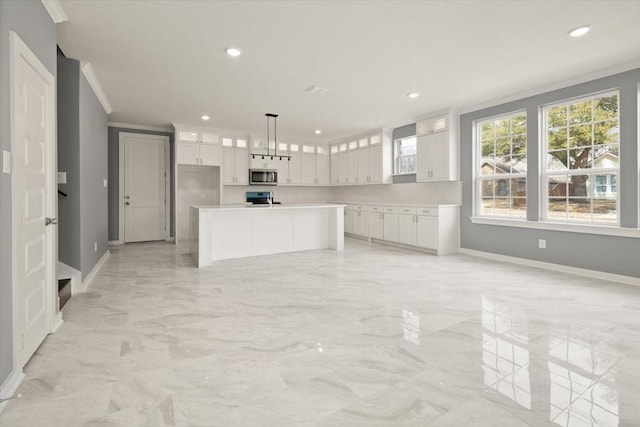 kitchen featuring stainless steel microwave, ornamental molding, glass insert cabinets, white cabinets, and range