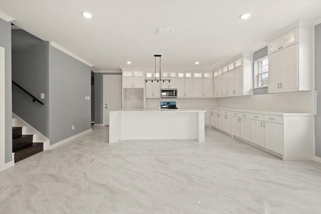 kitchen featuring visible vents, white cabinets, light countertops, appliances with stainless steel finishes, and glass insert cabinets