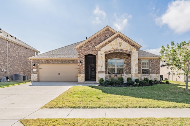 view of front of property with a front lawn, a garage, and cooling unit