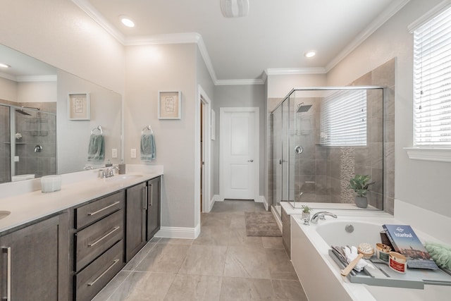 bathroom featuring vanity, a healthy amount of sunlight, crown molding, and separate shower and tub