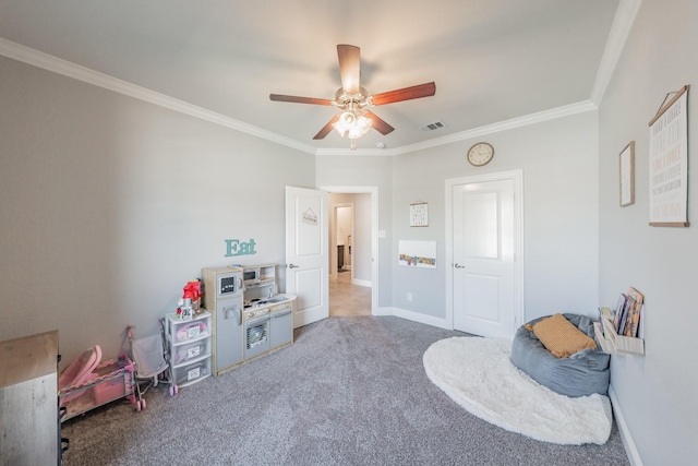 rec room with carpet flooring, ceiling fan, and ornamental molding