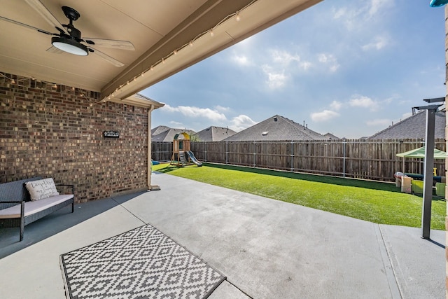 view of patio / terrace with a playground and ceiling fan