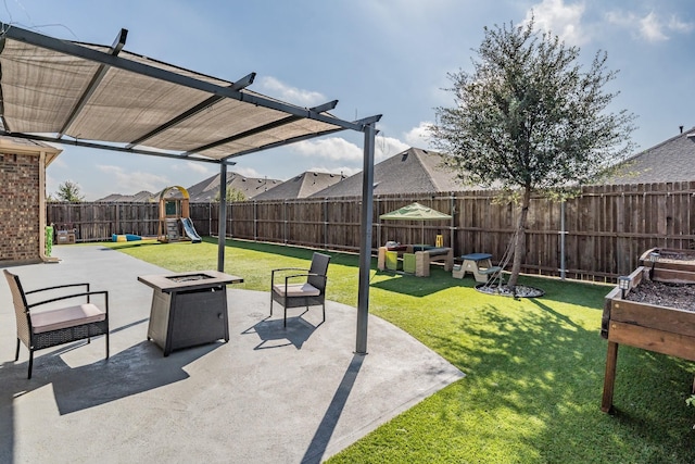 view of patio / terrace featuring a playground and a fire pit