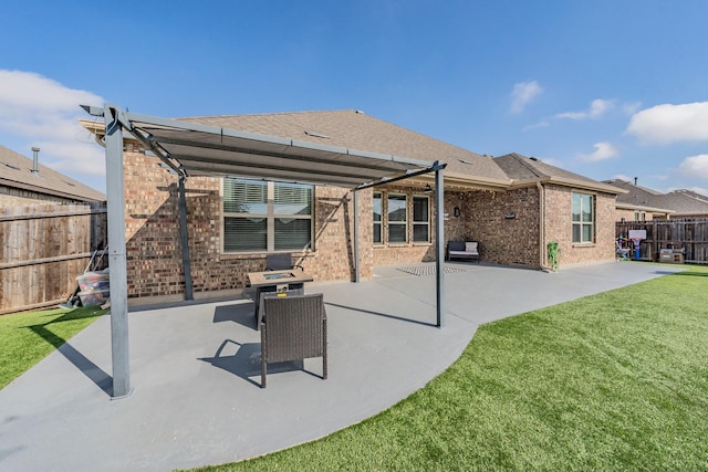 back of property with a yard and a patio