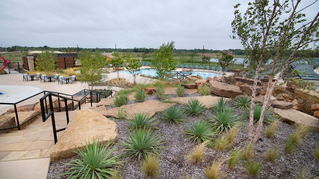 exterior space with a pool and a patio