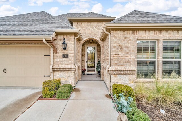 view of exterior entry with a garage