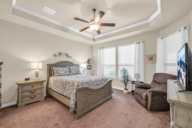 bedroom with a raised ceiling, ceiling fan, carpet floors, and ornamental molding