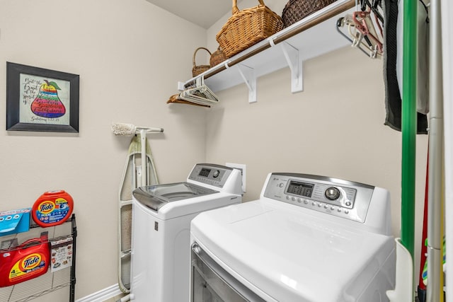 clothes washing area with separate washer and dryer