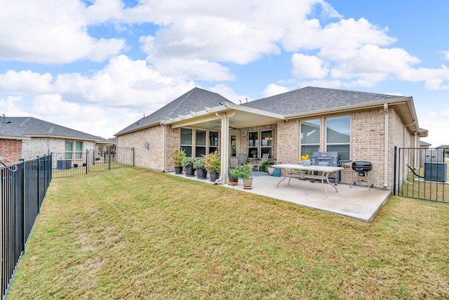 rear view of house featuring a yard and a patio