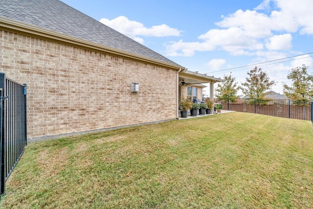 view of yard with ceiling fan