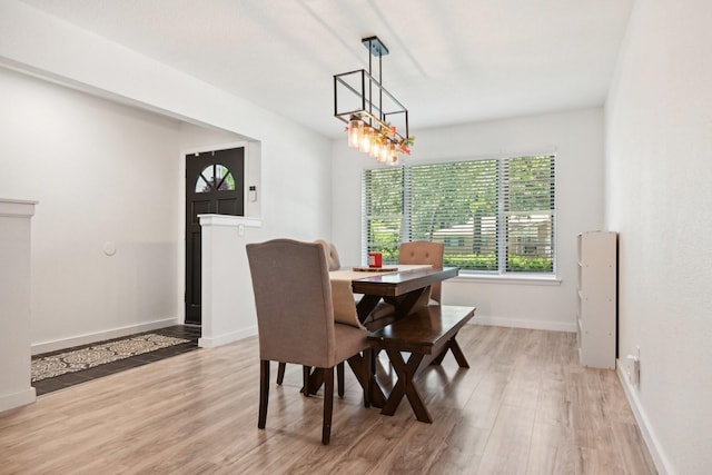 dining room with a chandelier and light wood-type flooring