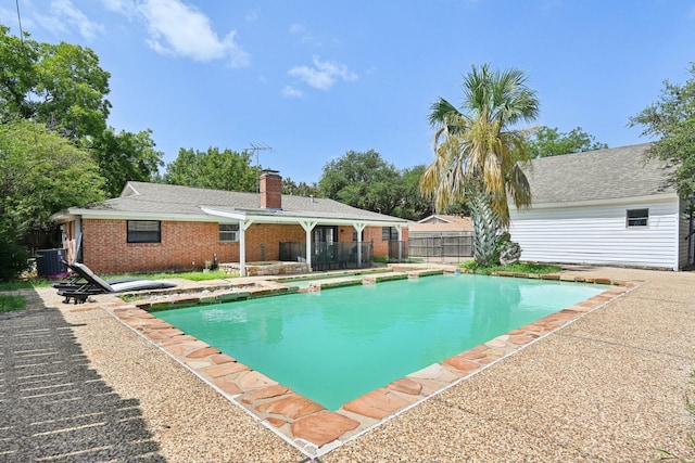 view of pool featuring cooling unit and a patio