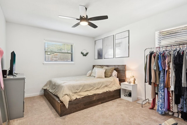 carpeted bedroom featuring a closet and ceiling fan