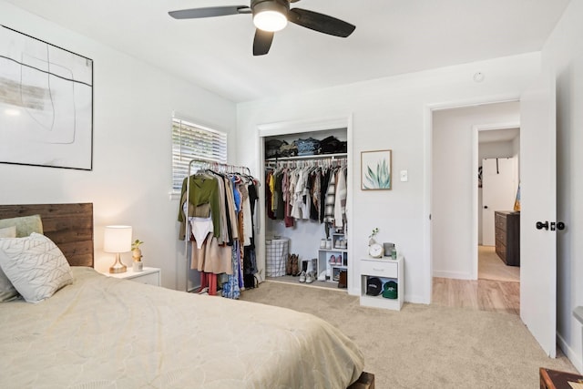 carpeted bedroom with ceiling fan and a closet