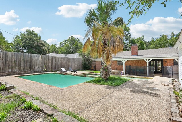 view of pool featuring an in ground hot tub and a patio area