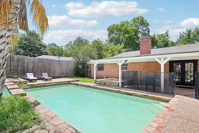 view of pool with a patio and french doors