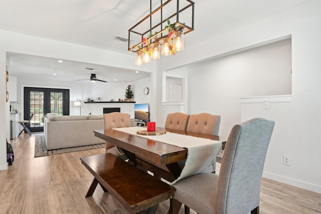 dining room featuring light hardwood / wood-style flooring, french doors, and ceiling fan