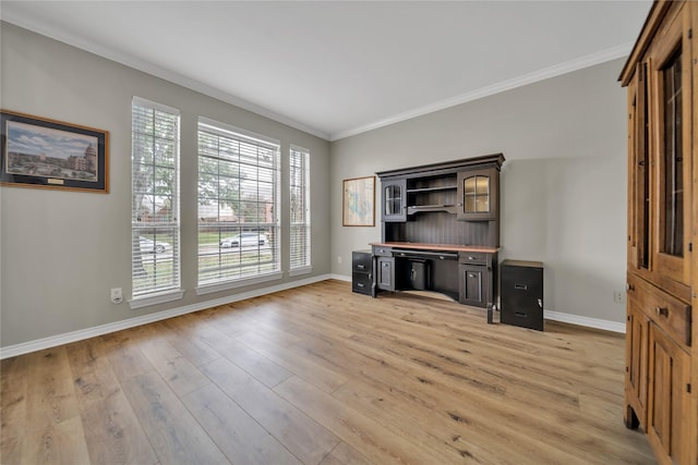 unfurnished office featuring a healthy amount of sunlight, light hardwood / wood-style floors, and ornamental molding