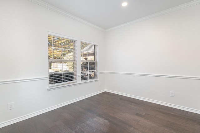 spare room with dark hardwood / wood-style flooring and crown molding