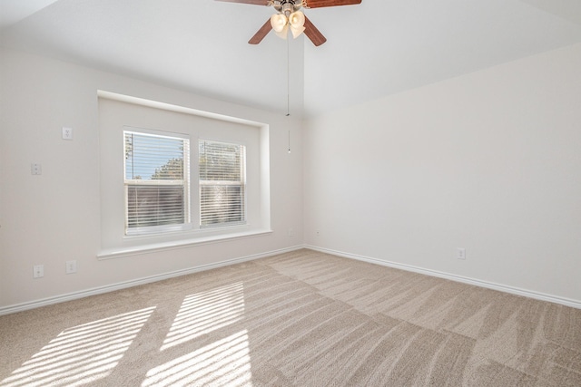 carpeted empty room featuring ceiling fan and vaulted ceiling