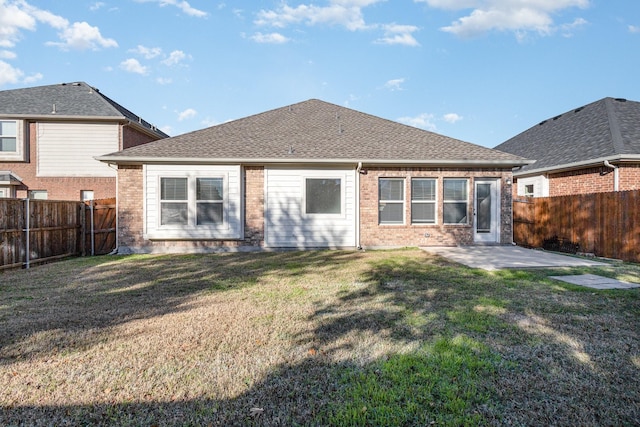 back of property featuring a patio area and a yard