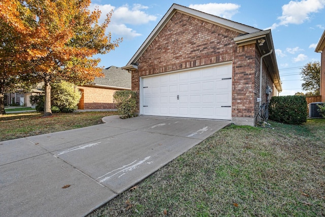 garage featuring central AC unit and a lawn