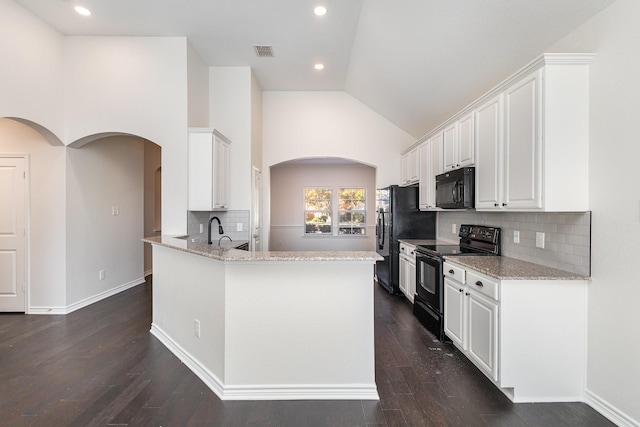 kitchen with decorative backsplash, dark hardwood / wood-style flooring, white cabinets, and black appliances