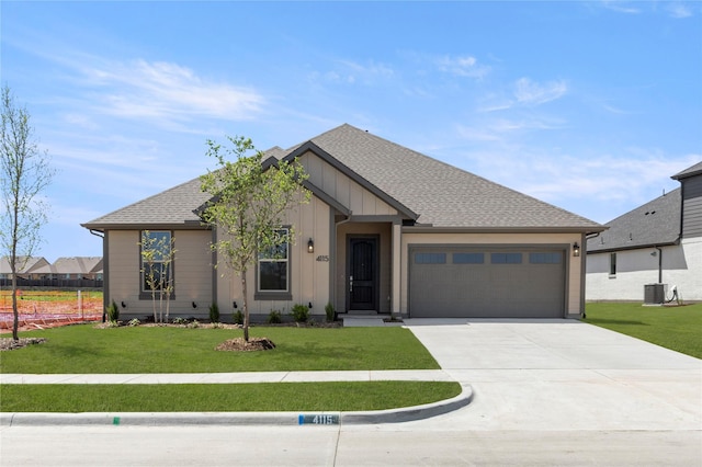 ranch-style house featuring board and batten siding, a garage, roof with shingles, a front lawn, and concrete driveway