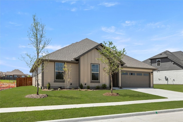 view of front of home with a front yard, board and batten siding, concrete driveway, an attached garage, and fence