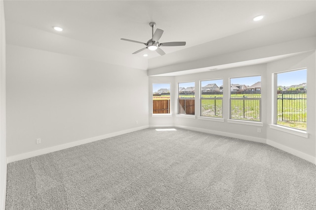 carpeted spare room with recessed lighting, a ceiling fan, and baseboards
