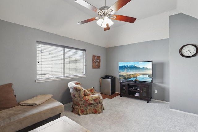 carpeted living room featuring vaulted ceiling and ceiling fan