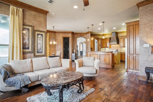 living room with ornamental molding, dark hardwood / wood-style floors, and ceiling fan