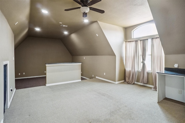 bonus room featuring light carpet, vaulted ceiling, and ceiling fan