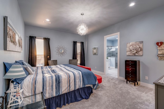 bedroom with light carpet, connected bathroom, and a notable chandelier