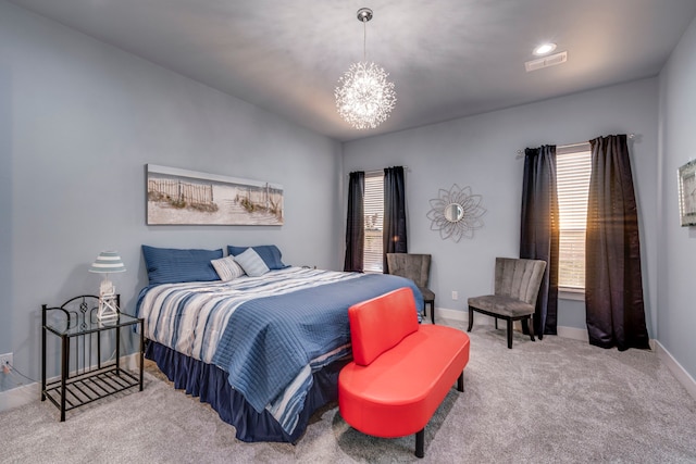 carpeted bedroom with a chandelier