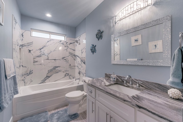 full bathroom featuring toilet, tiled shower / bath combo, and vanity