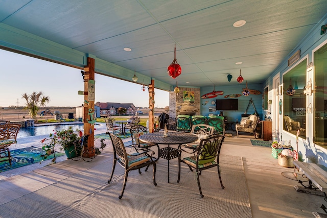 view of patio with pool water feature and a water view